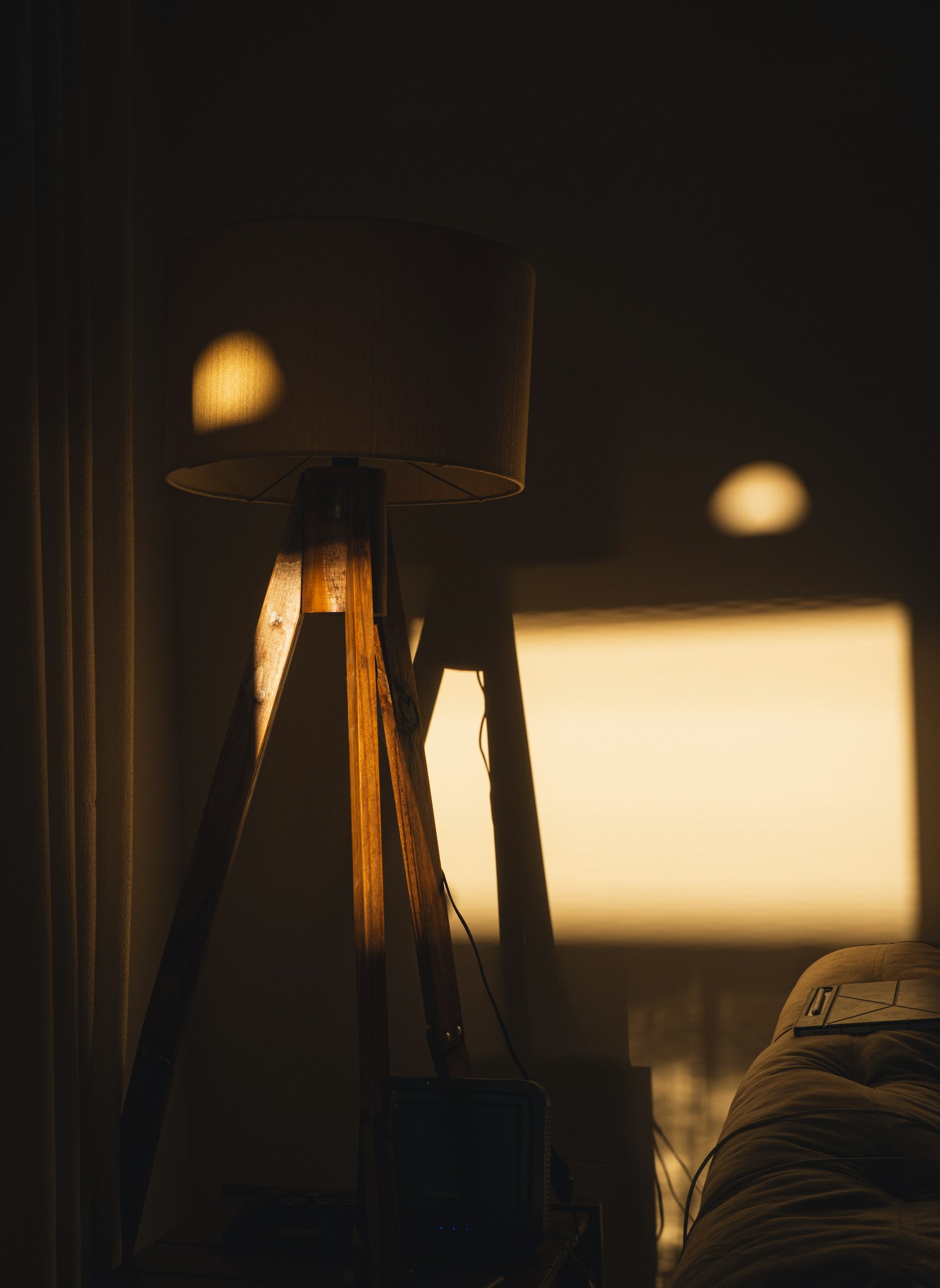 A floor lamp casting warm light in a dim interior